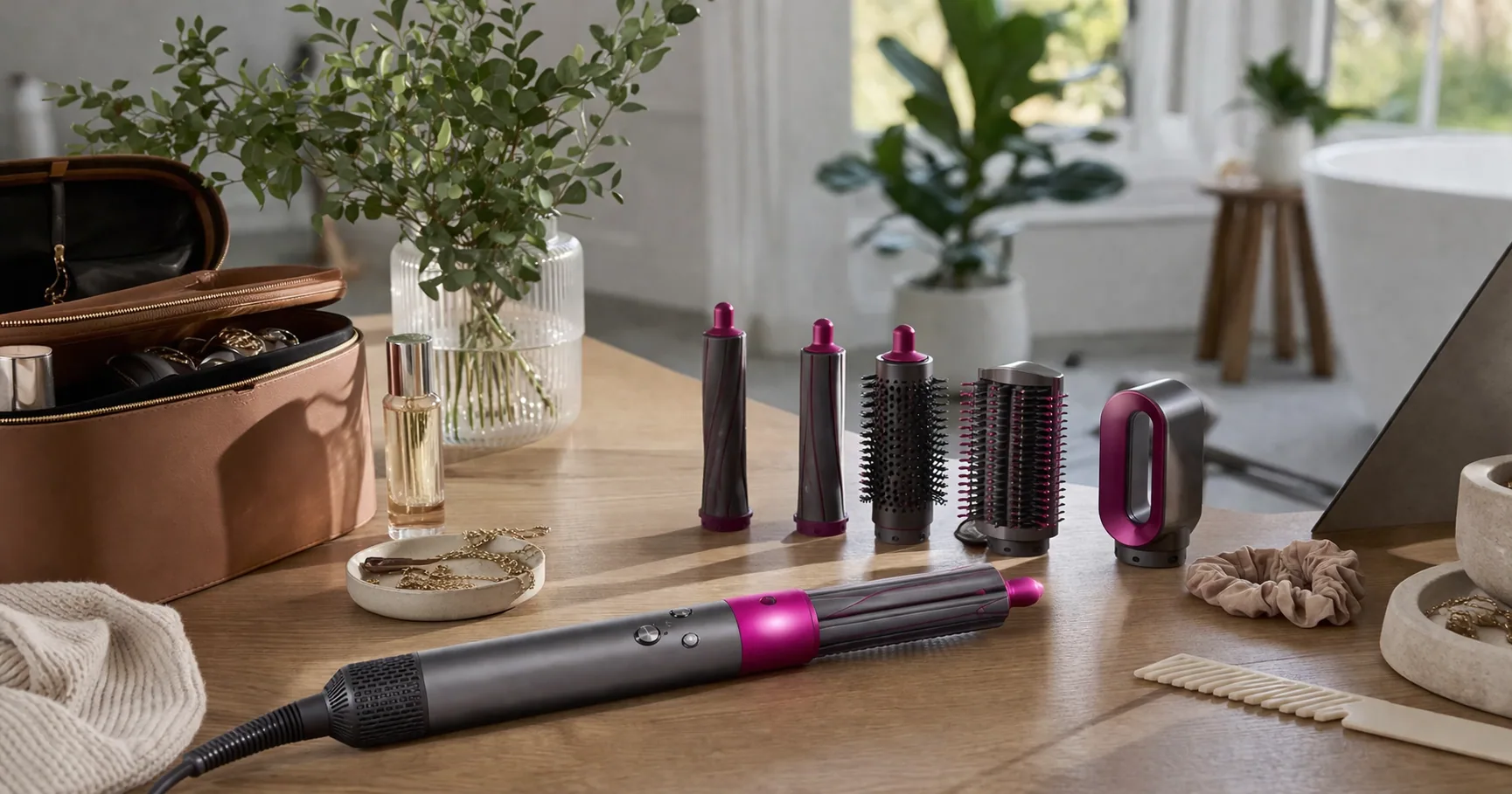 Dyson Airwrap styler with curling and brush attachments laid out on a bathroom counter